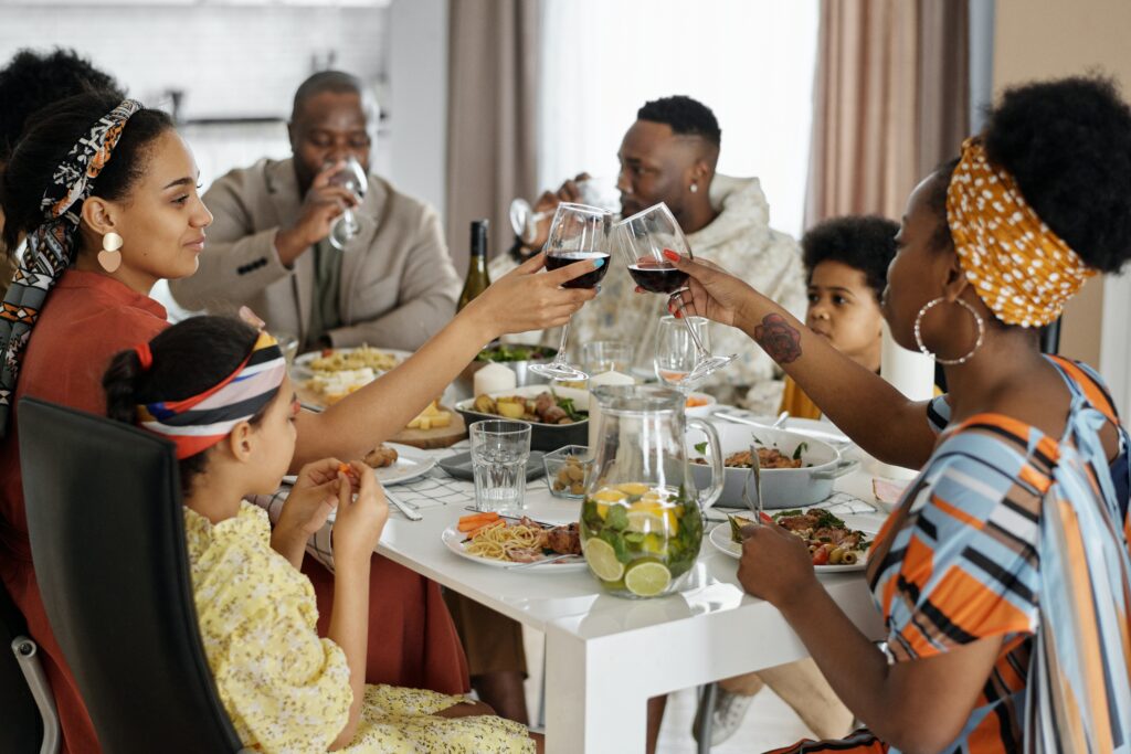 Family and friends using tableware for a meal at the table