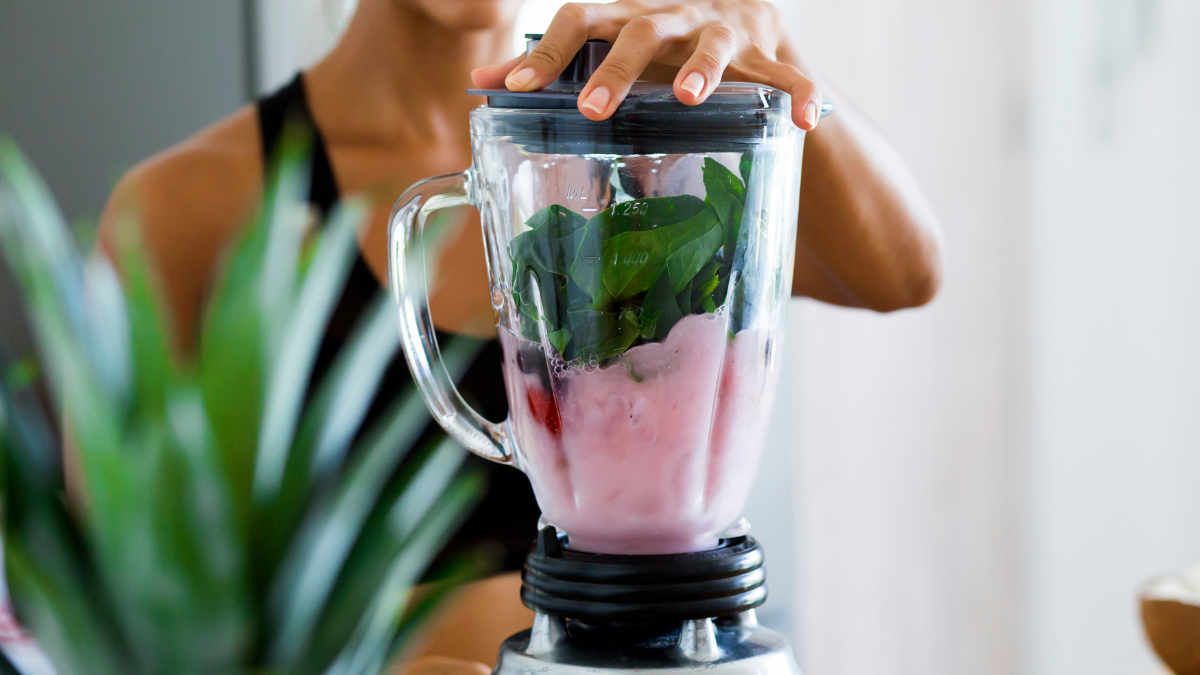 Woman using a blender to make a smoothie